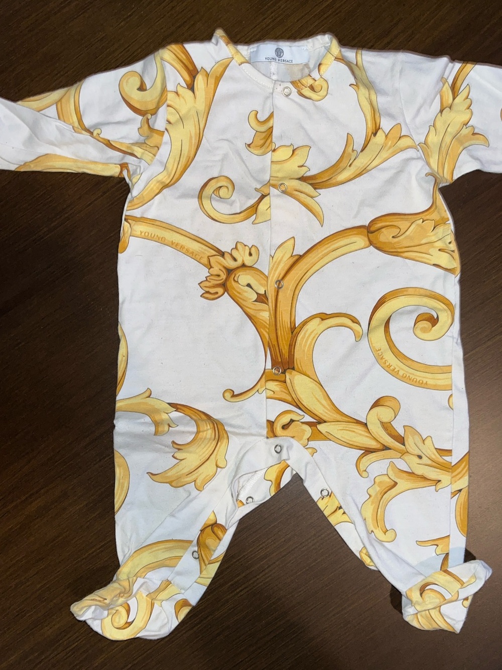 Young Versace One-Piece Footed Sleeper in White with Gold Scroll Print